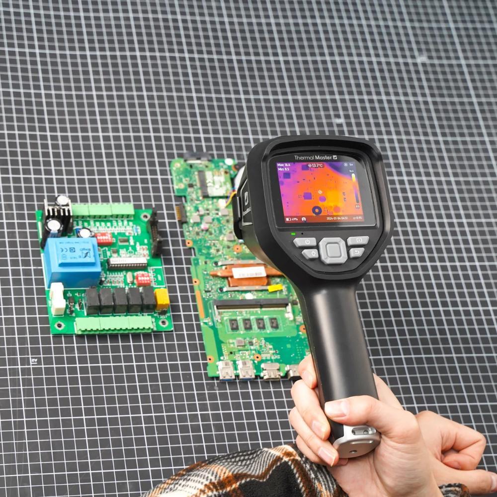 Thermal camera examining electronic circuit boards during laboratory testing