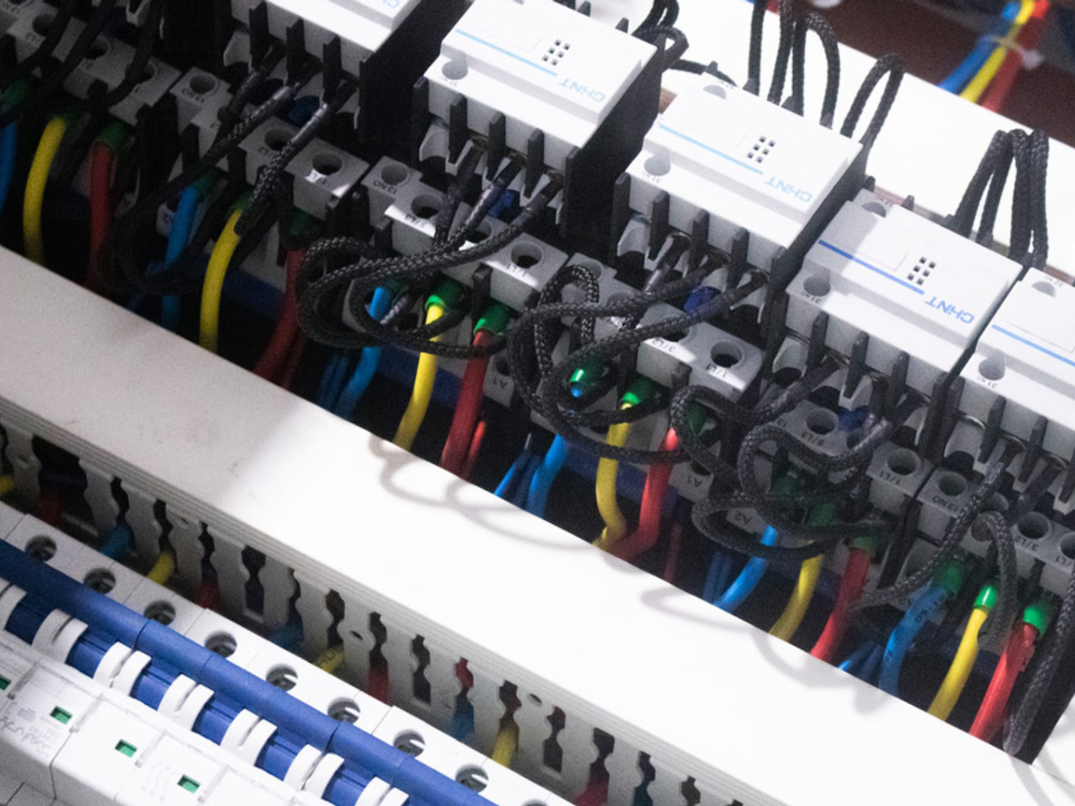 Close-up visible-light view of contactors, terminals and wiring inside an electrical switchboard.