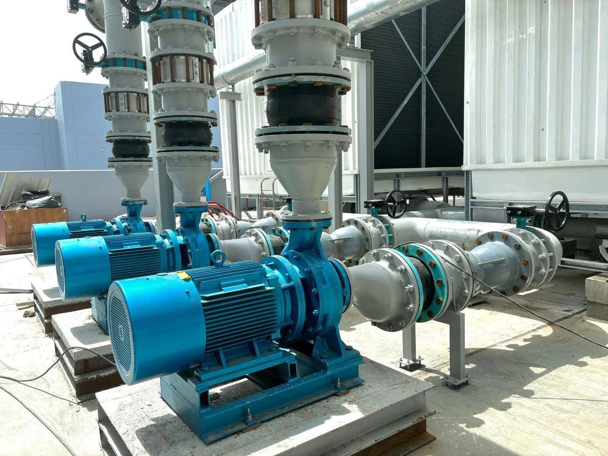 Industrial motor-driven centrifugal pumps and connected pipework in an outdoor industrial facility