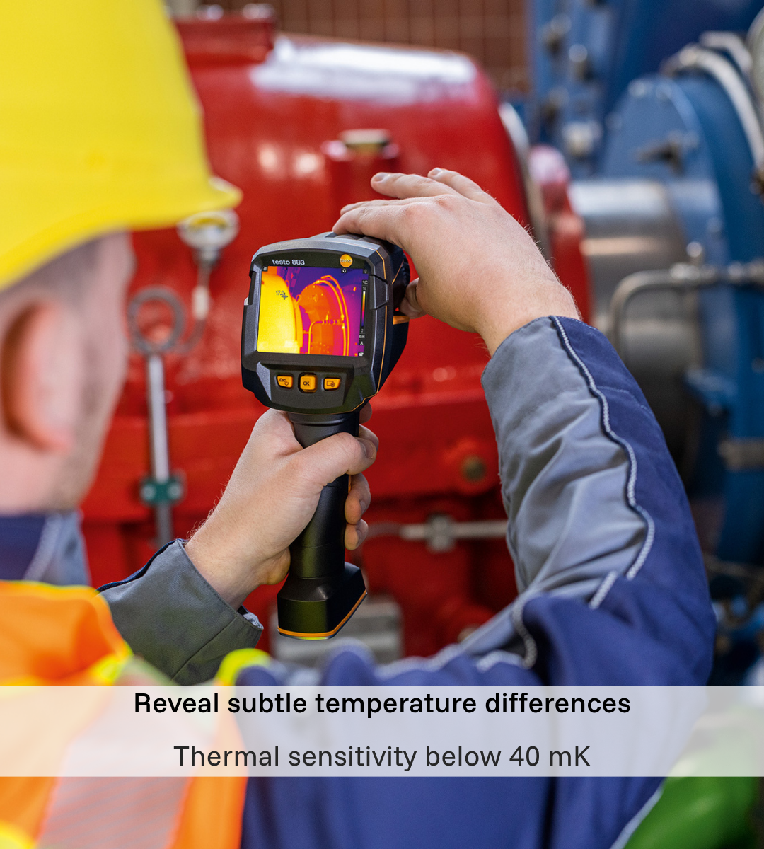 Maintenance engineer inspecting industrial machinery with a Testo 883 thermal camera