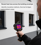 Testo 883-2 thermal camera inspecting heat loss across a building façade